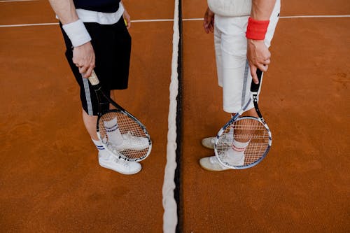 People Holding Tennis Rackets