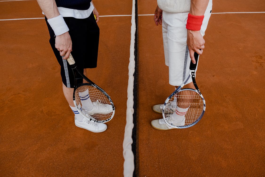 People Holding Tennis Rackets