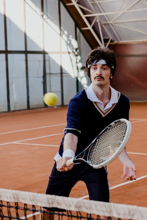 A Man with Mustache Playing Tennis