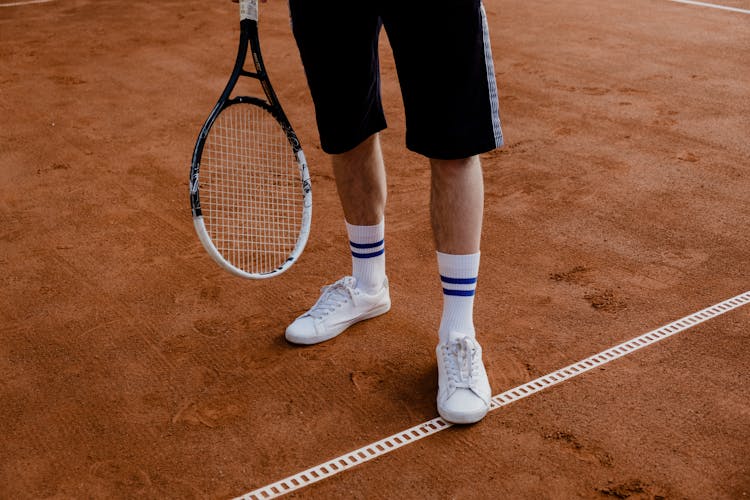 A Man Holding A Tennis Racket