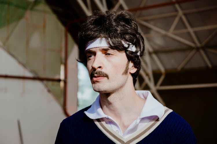 A Man With Mustache Wearing A Sweatband