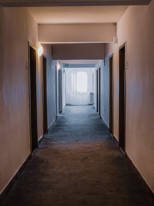 Narrow illuminated hallway in building