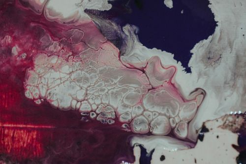 Free From above of bright abstract background representing curved lines and blots with mix of paint tones Stock Photo