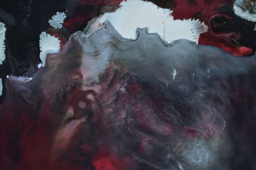 Free Overhead view of abstract backdrop of blended paints creating curved lines and blots Stock Photo