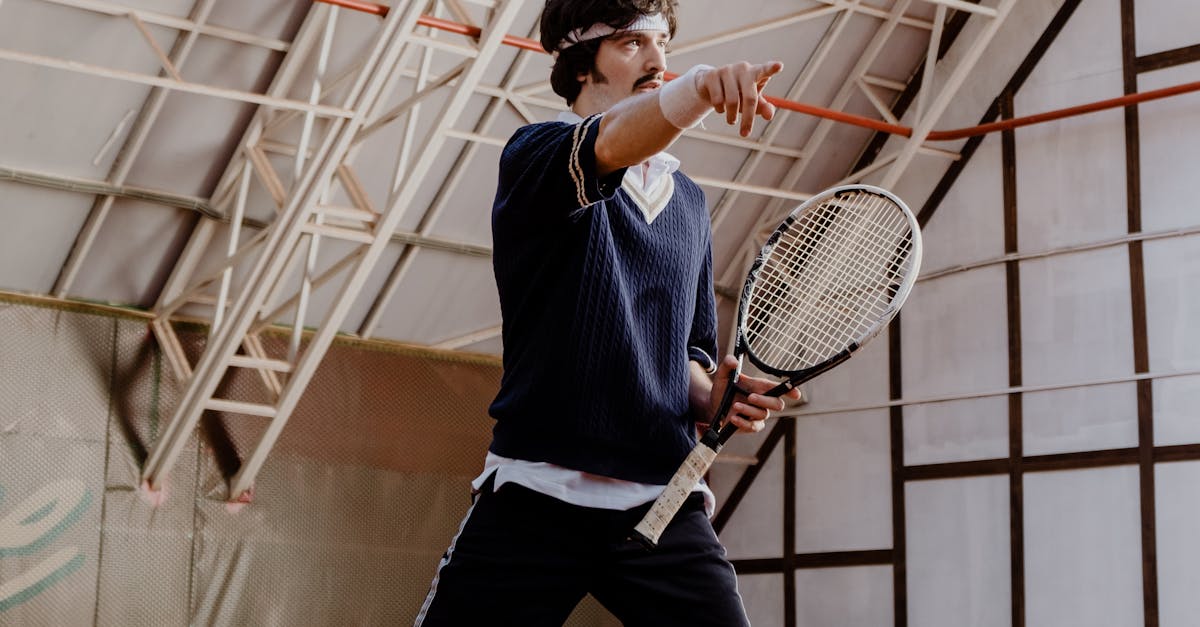 A Tennis Player Pointing while Holding a Racket · Free Stock Photo