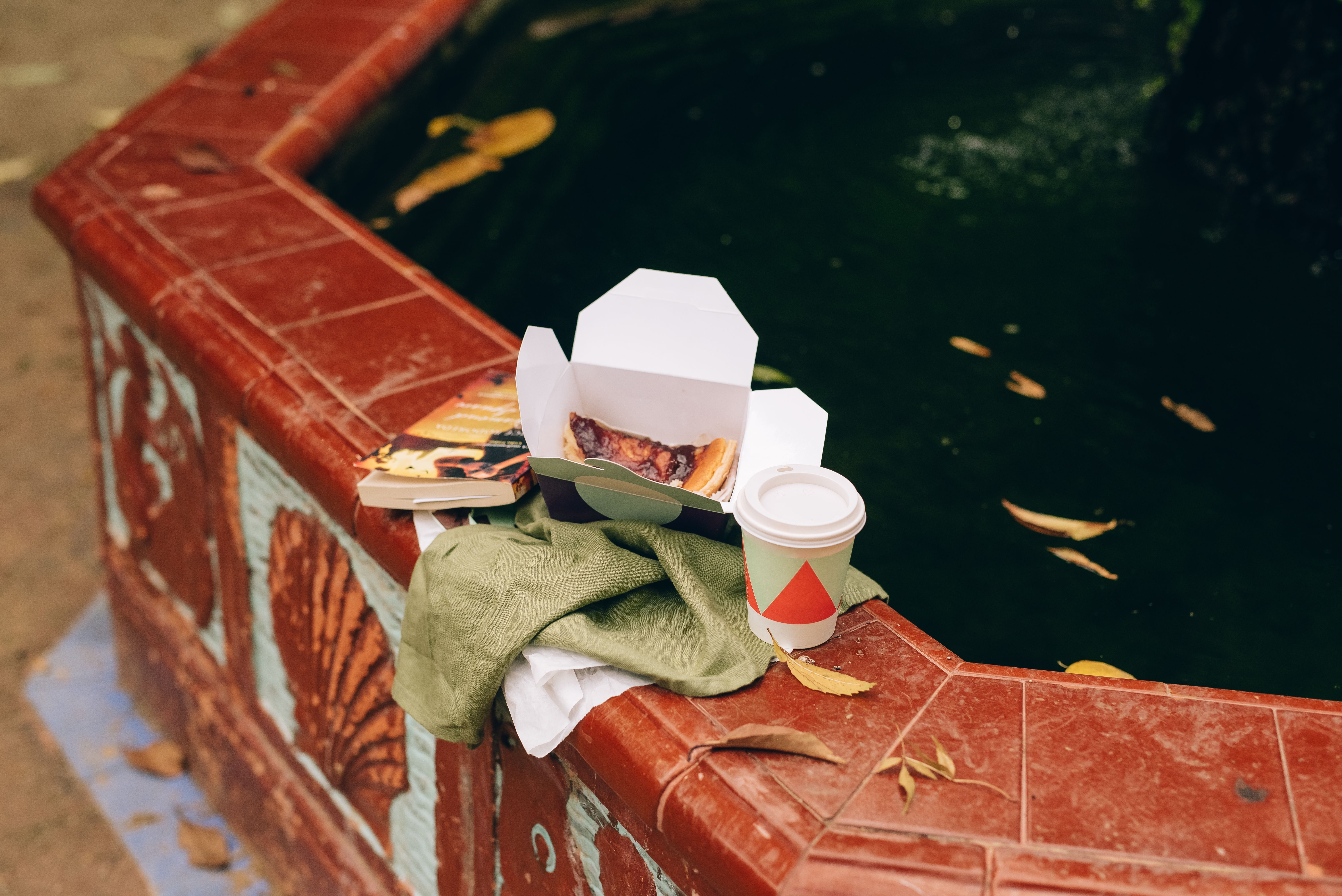 White Paper Cup on the Concrete Fence · Free Stock Photo