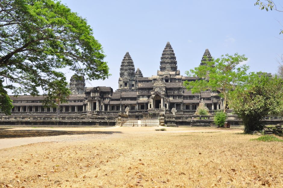 Traditional tuk-tuk parked near an ancient temple at Angkor, Cambodia