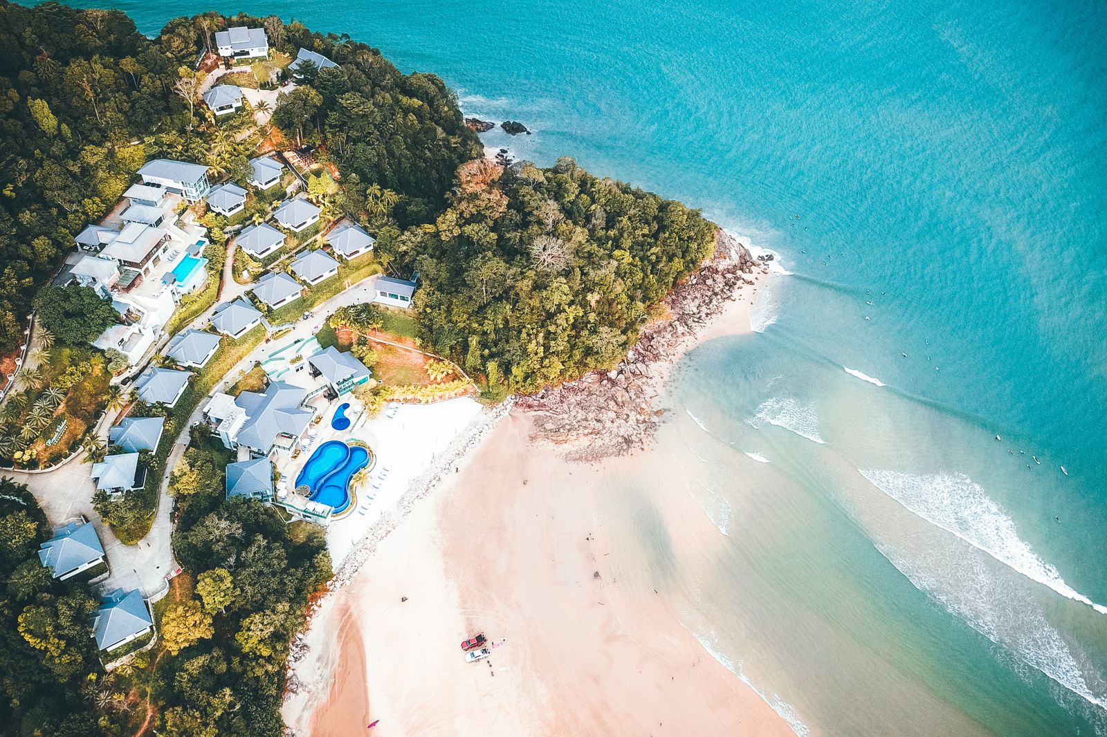Tropical resort with palm trees and swimming pools overlooking the ocean