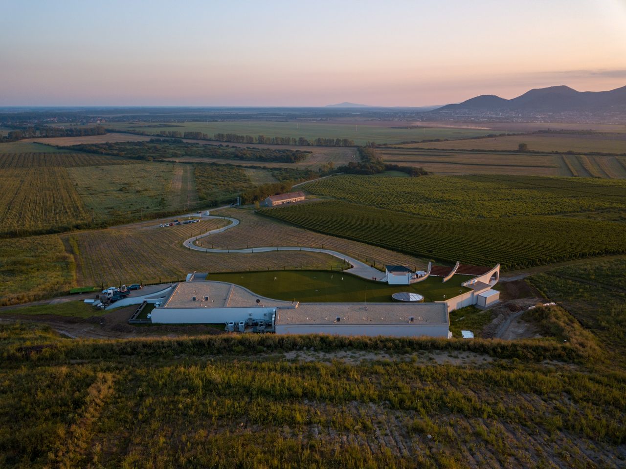aerial shot of agricultural fields in bara slovakia at sunset showcasi