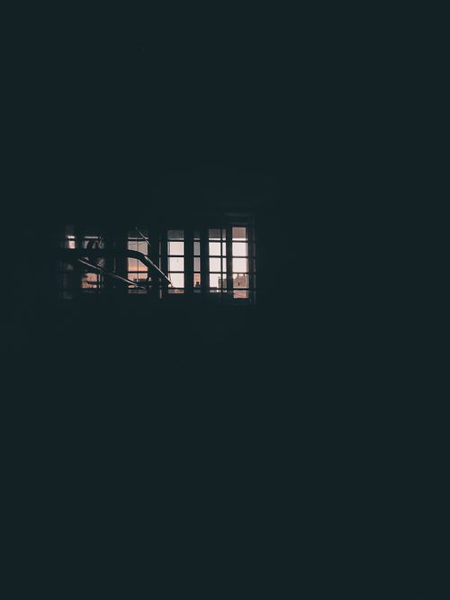 Free Moody image of an illuminated window casting light into the dark interior of a building. Stock Photo