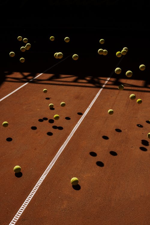 Free Tennis Balls on the Tennis Court Stock Photo