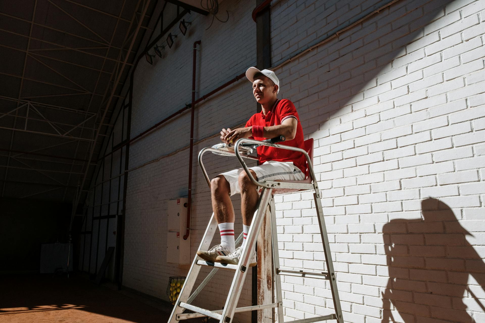 An Umpire Sitting on Elevated Chair