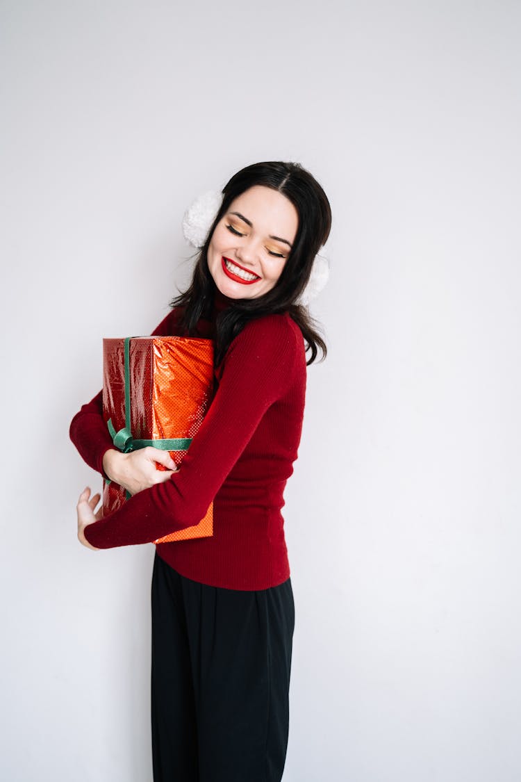 A Woman Hugging A Red Gift Box