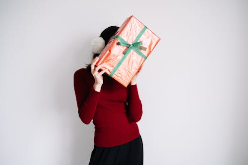 Free A Woman Hiding Behind a Gift Box Stock Photo