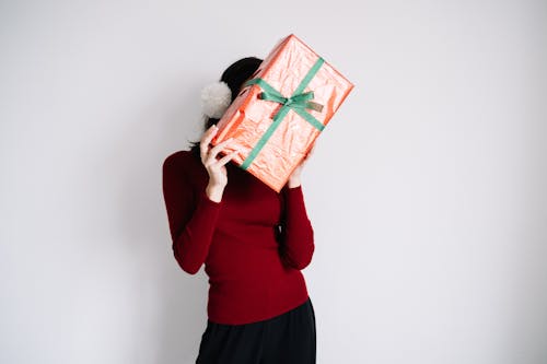 A Woman Hiding Behind a Gift Box