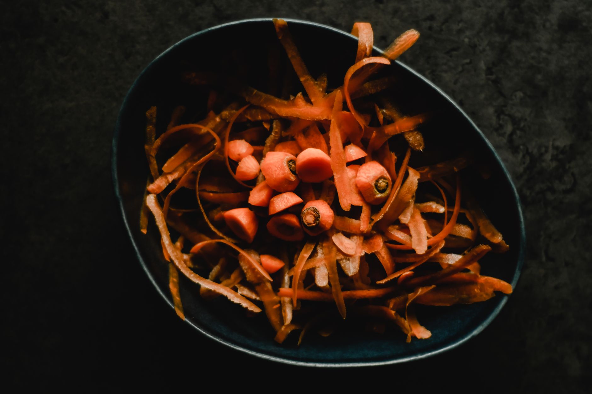 Golden crispy vegetable scrap crackers served in a rustic bowl