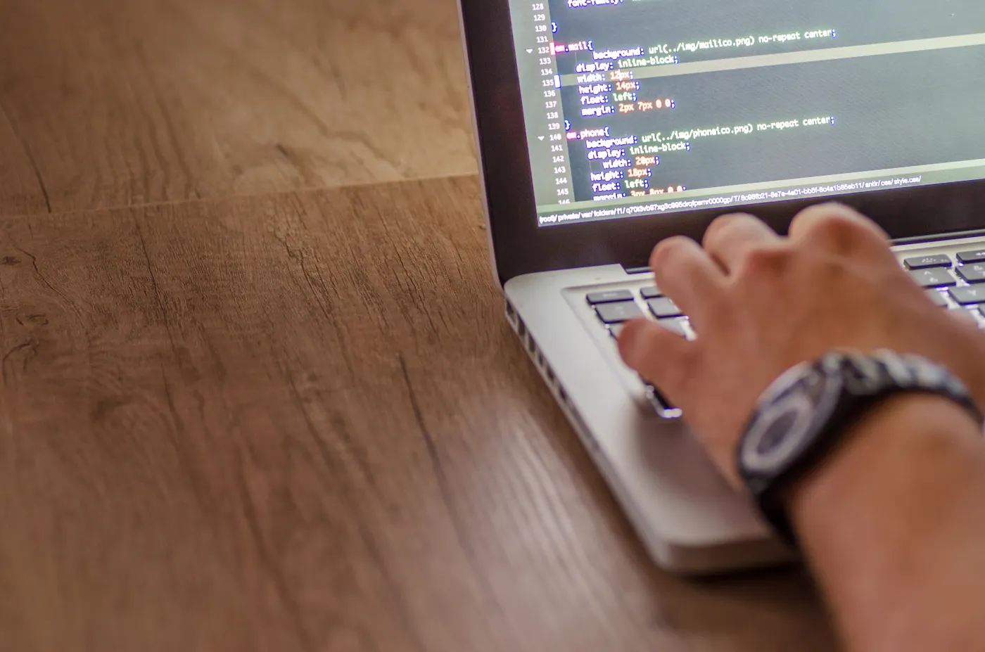 Developer coding on a laptop