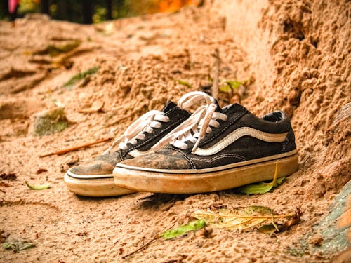 A Close-Up Shot of a Pair of Muddy Sneakers