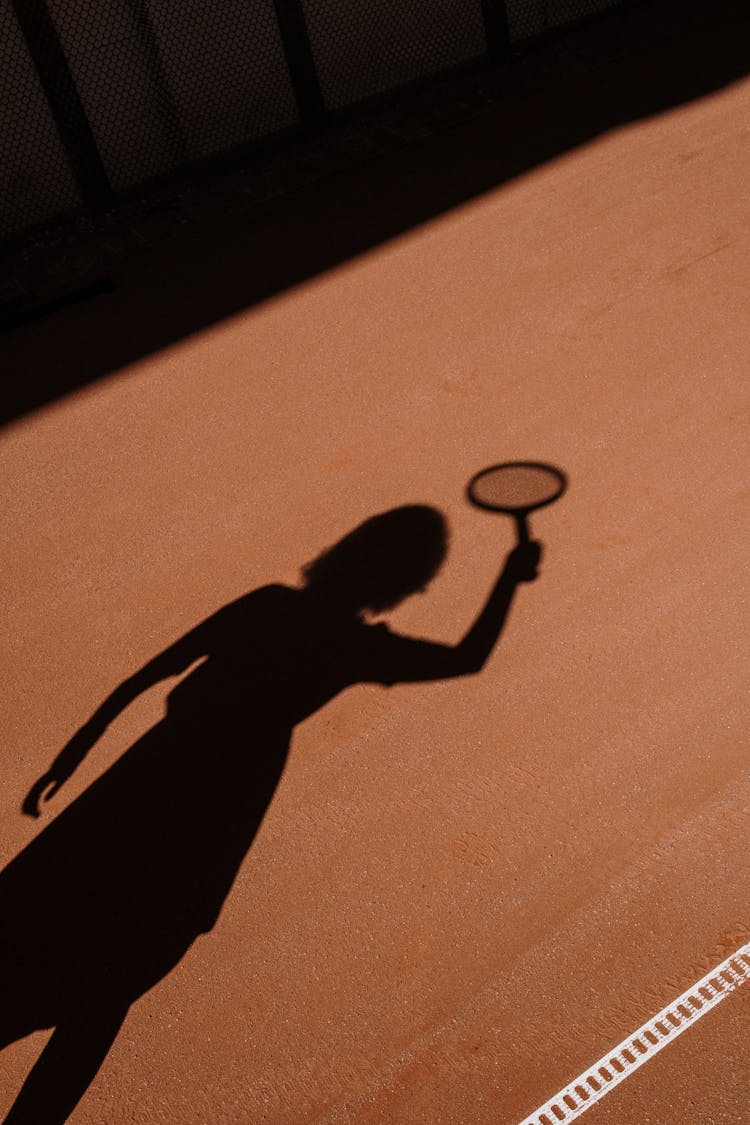 Shadow Of Person Holding A Tennis Racket