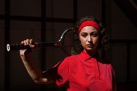 Woman in Red Dress Holding Red and Black Tennis Racket