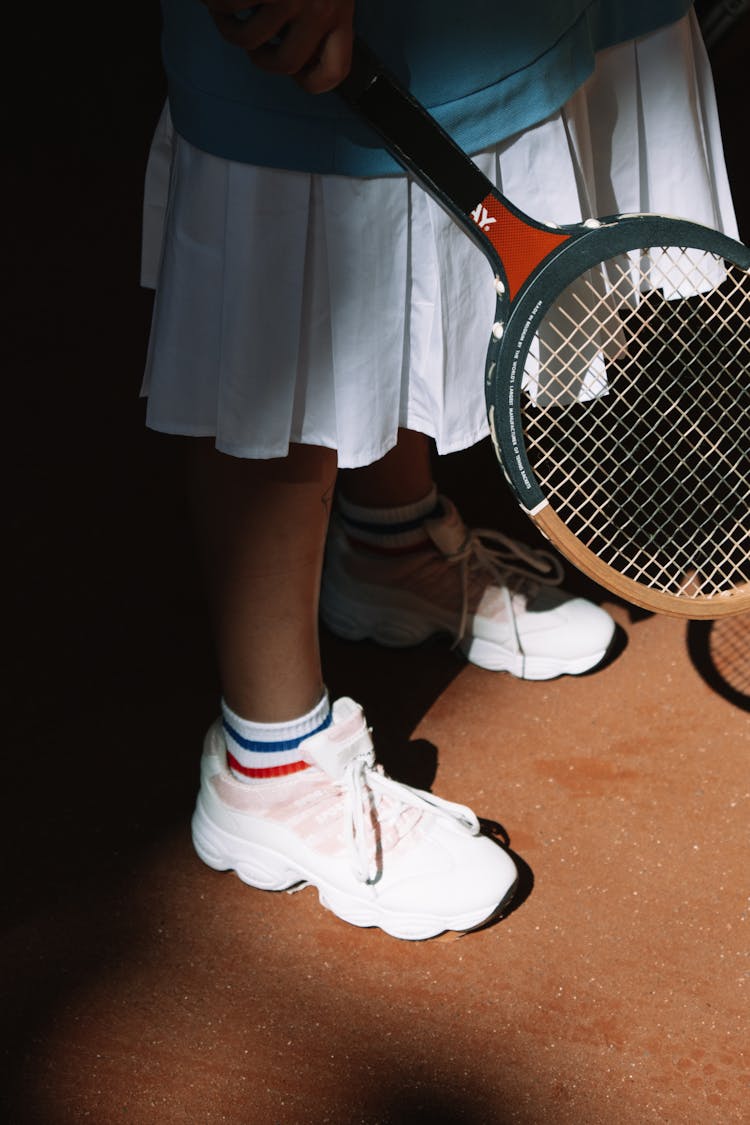 A Person Holding A Tennis Racket