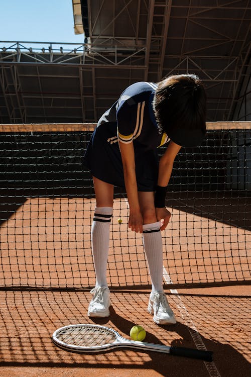 An Athlete Fixing Her Socks