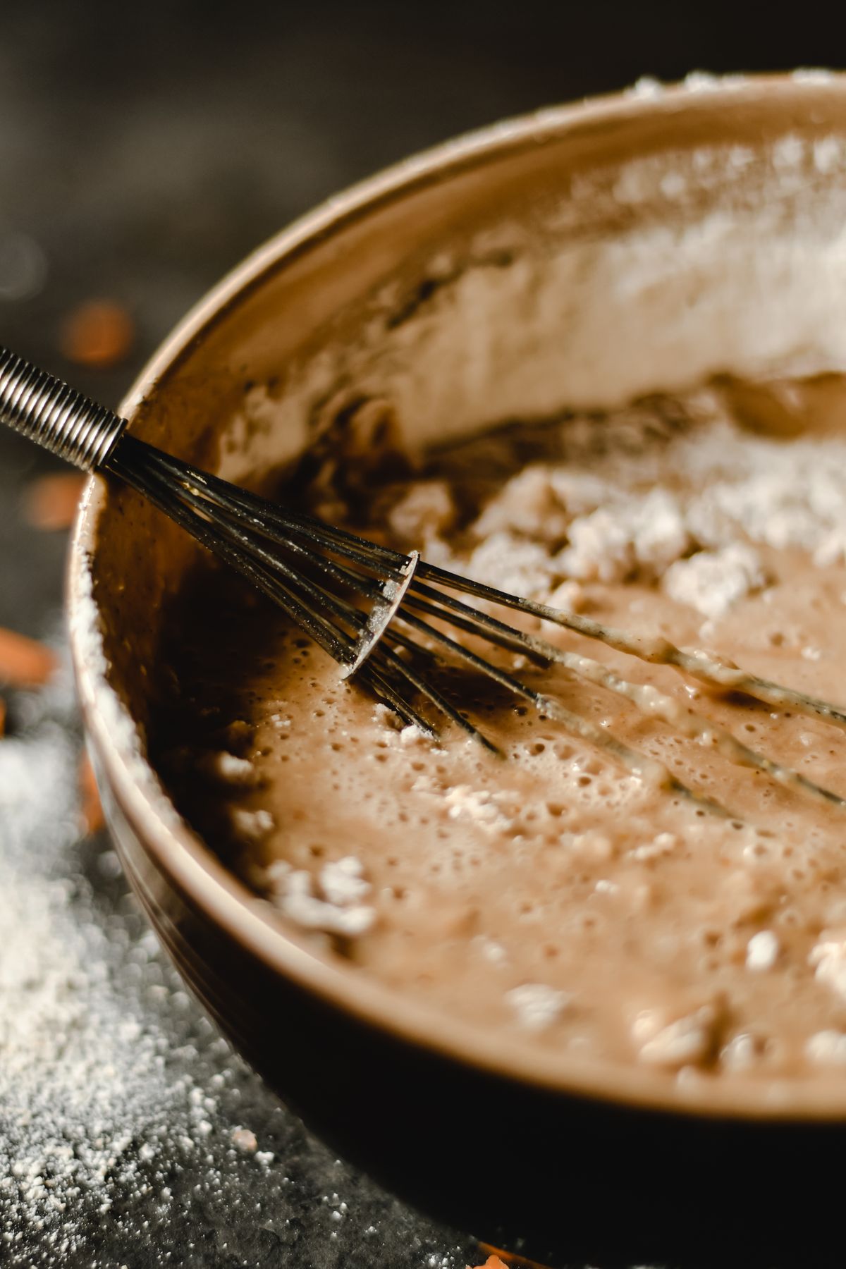 Smooth batter in a bowl with a whisk resting on top