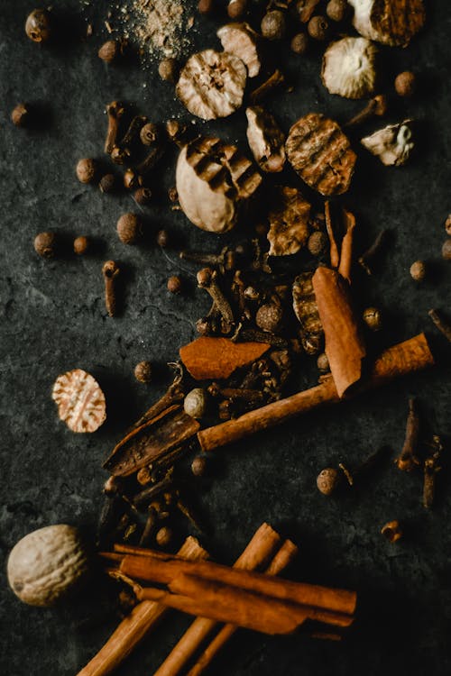 Dried Herbs and Spices on Black Surface