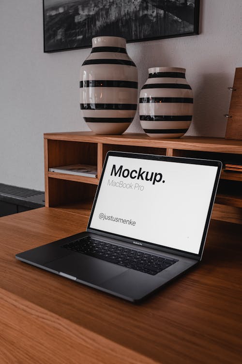 Free A Macbook Pro on Top of a Wooden Desk Stock Photo