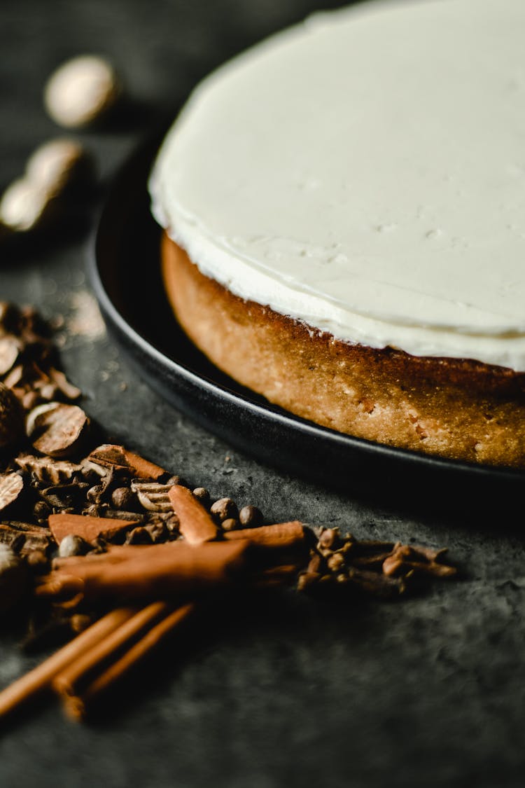 Dried Herbs And Spices Near A Cake With Icing