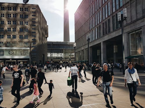 Man in Black Crew-neck T-shirt Walking Near Building