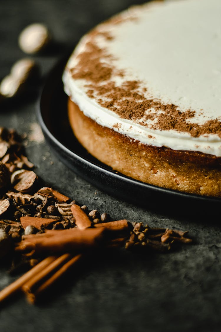 Cinnamon Powder Toppings On A Cake With Icing