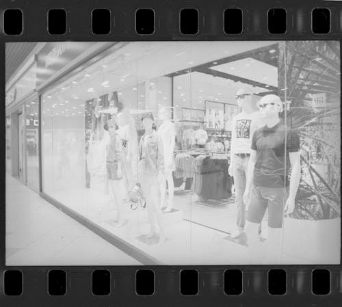 Mannequins on the Store Window Display with Film Reel Frame 