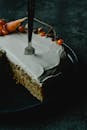 Sliced Cake With Stainless Steel Fork on Black Ceramic Plate