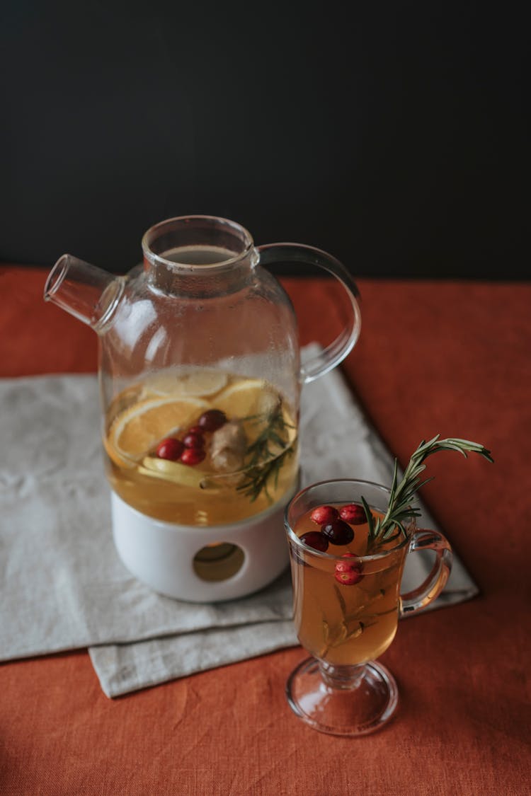 Beverage On A Glass Cup With Cranberries And Rosemary 