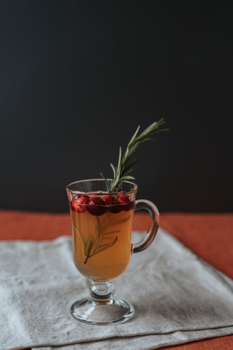 A Glass Of Cranberry Juice With Rosemary