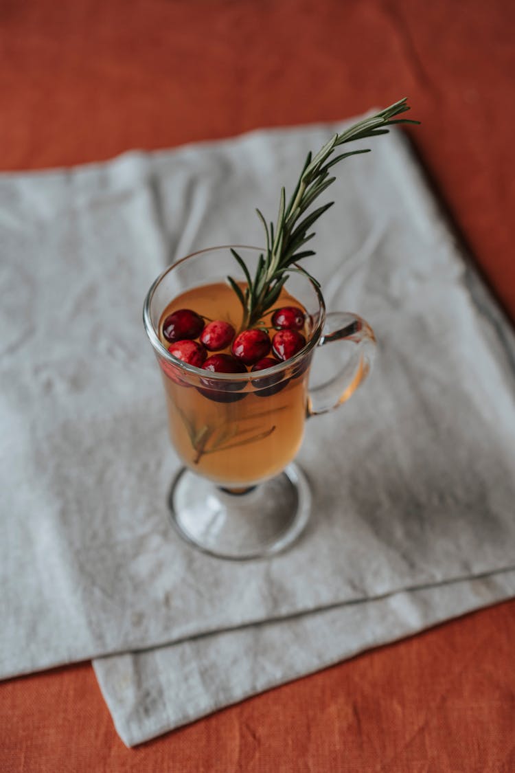A Glass Of Cranberry Juice With Rosemary