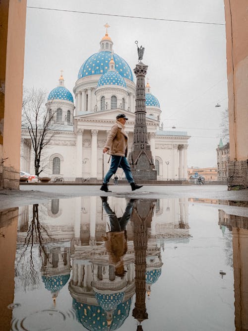 Anonymous woman walking near ancient cathedral during sightseeing trip