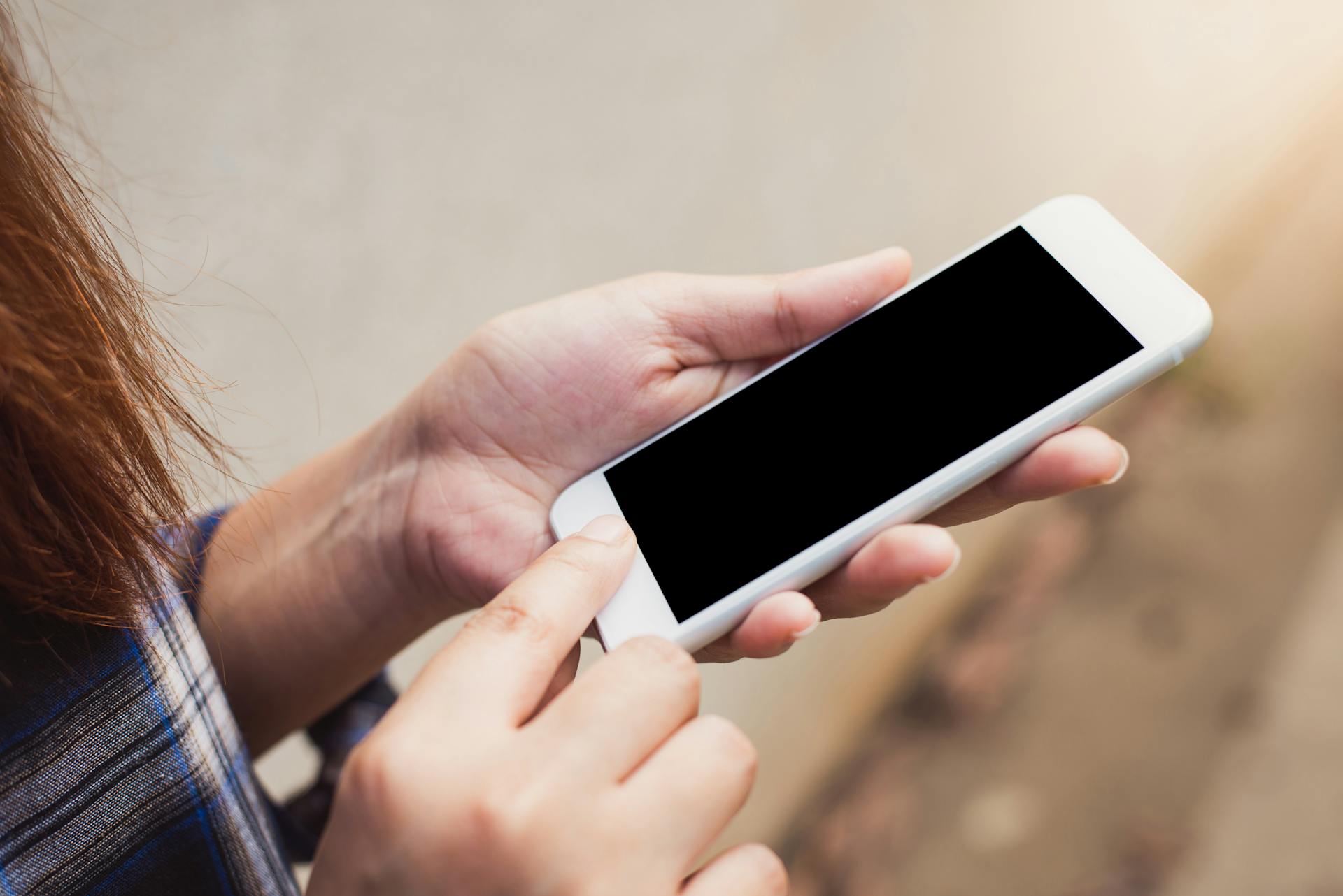 Person Holding Silver Iphone 6 Displaying Black Screen