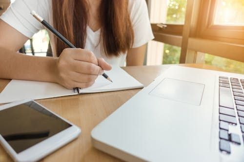 Free Woman About to Write on Paper Stock Photo