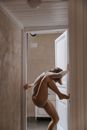 Woman in White Long Sleeve Shirt Bending Her Body