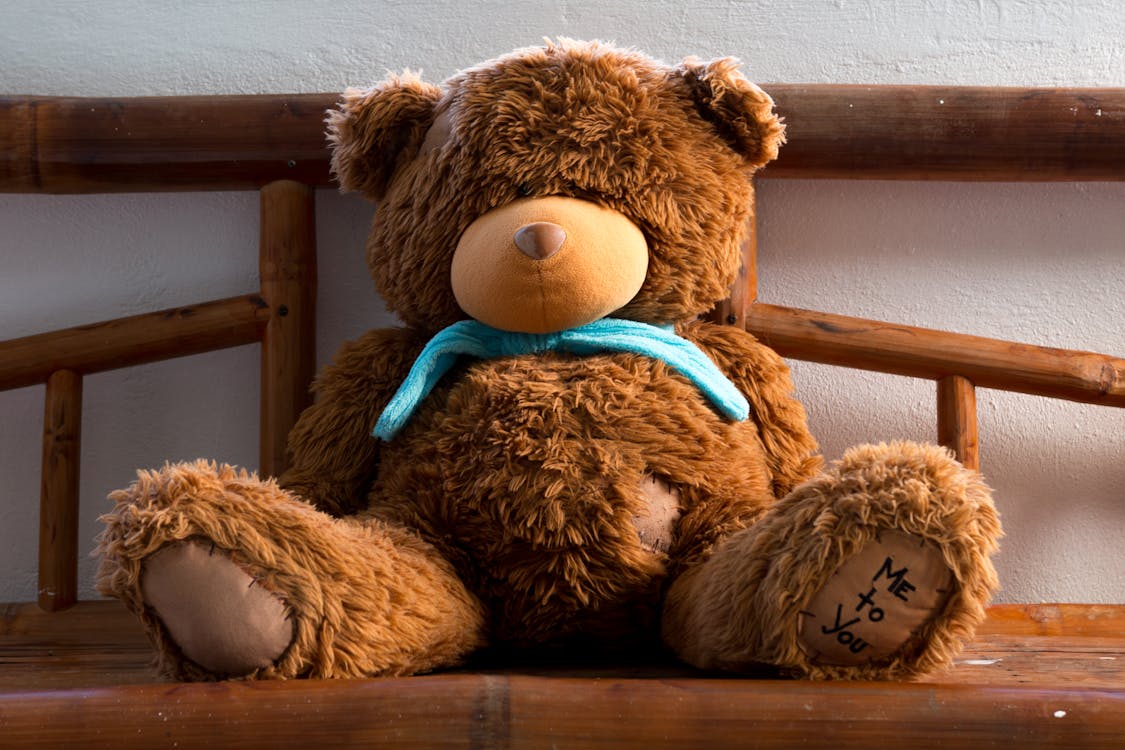 Free Brown Teddy Bear on Brown Wooden Chair Stock Photo