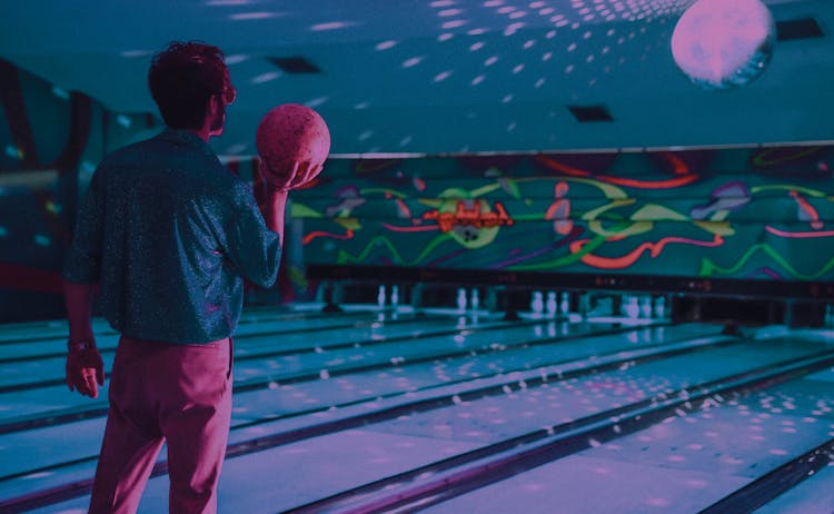 Unrecognizable Man Standing Near Bowling Lane