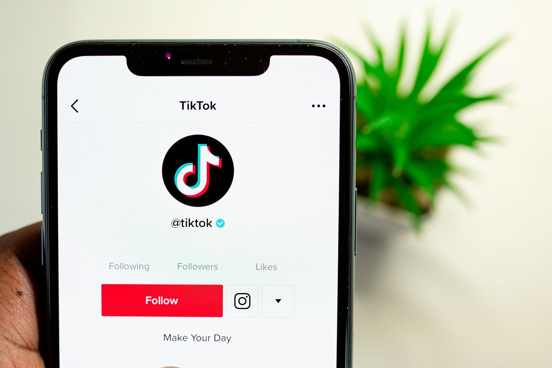 Start a TikTok Account on Your Phone: A Simple, Step-by-Step Guide Close-up view of hand holding smartphone displaying TikTok app interface with profile page.
