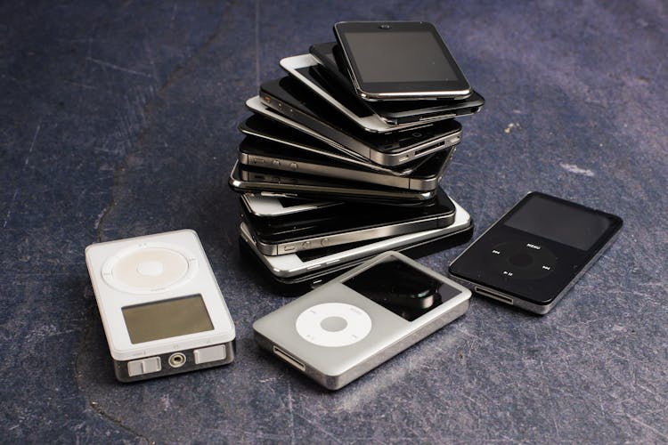 Collection Of Music Players And Pile Of Old Smartphones