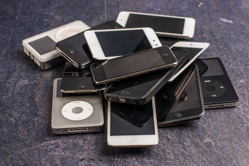 Pile of old smartphones and music players
