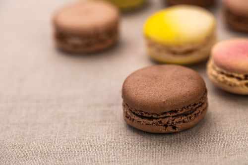 Free Collection of tasty baked meringue biscuits with smooth fillings between crunchy layers on blurred background Stock Photo
