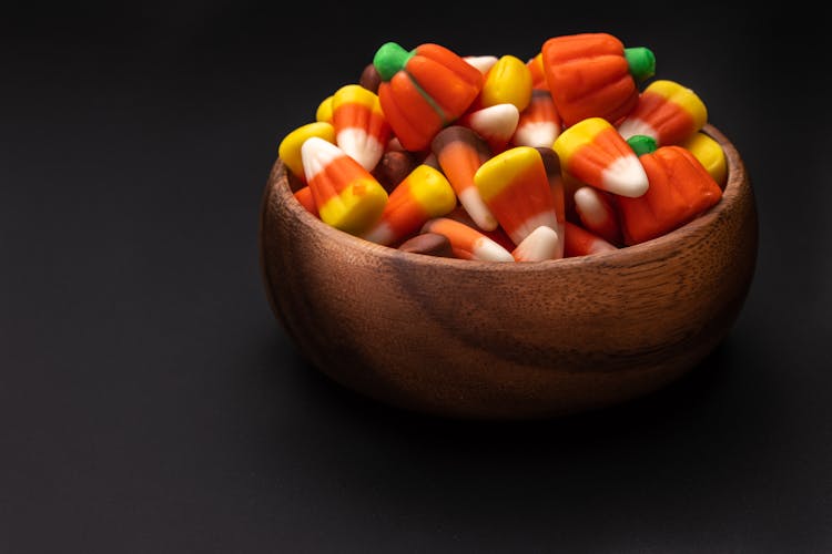 Bowl Full Of Colorful Gummies On Black Background