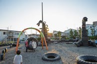 Suburb yard with figures made of tyres