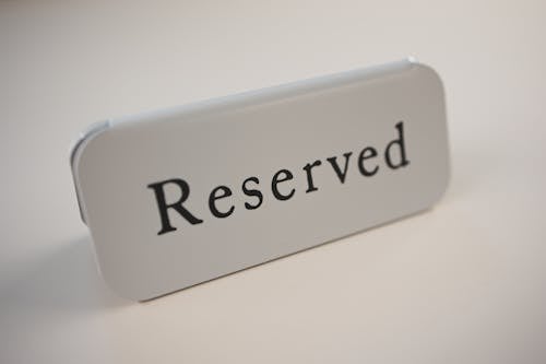 Free Metal signage with black letters saying Reserved on gray background used in cafes and restaurants Stock Photo